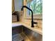 Modern black gooseneck kitchen faucet and sink at 747 Dogwood Cir, Norcross, GA 30071