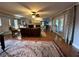 Spacious living room featuring hardwood floors, fireplace, ceiling fan, and plenty of natural light at 747 Dogwood Cir, Norcross, GA 30071