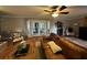 Cozy living room featuring a fireplace, hardwood floors, ceiling fan, and french doors at 747 Dogwood Cir, Norcross, GA 30071