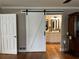 View of a white barn door leading to the ensuite bathroom at 747 Dogwood Cir, Norcross, GA 30071