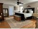 Spacious main bedroom with a ceiling fan, hardwood floors, and an elegant bed at 747 Dogwood Cir, Norcross, GA 30071