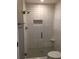 Walk-in shower featuring a glass door, subway tile, and a built-in niche at 747 Dogwood Cir, Norcross, GA 30071