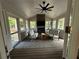Inviting sun room with ceiling fan, stone fireplace, and comfortable seating at 747 Dogwood Cir, Norcross, GA 30071