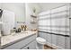 Clean bathroom with granite countertop, shower, and stylish striped curtain at 2647 Old Snapping Shoals Rd, Mcdonough, GA 30252
