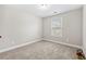 Simple bedroom with neutral color palette and carpeted floor at 2647 Old Snapping Shoals Rd, Mcdonough, GA 30252