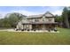 Two-story house with gray siding, brown accents, and a large front yard at 2647 Old Snapping Shoals Rd, Mcdonough, GA 30252