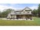 Two-story house with gray siding, brown accents, and a large front yard at 2647 Old Snapping Shoals Rd, Mcdonough, GA 30252