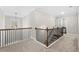 Upper hallway with iron railings and carpeted floor at 2647 Old Snapping Shoals Rd, Mcdonough, GA 30252