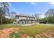 Two-story house back view with covered patio and large backyard at 2647 Old Snapping Shoals Rd, Mcdonough, GA 30252