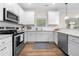 Modern kitchen with white cabinets, stainless steel appliances, and granite countertops at 2647 Old Snapping Shoals Rd, Mcdonough, GA 30252