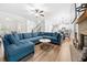 Spacious living room with sectional sofa, hardwood floors, fireplace and kitchen view at 2647 Old Snapping Shoals Rd, Mcdonough, GA 30252