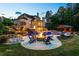 Backyard with a custom pool, spa, waterfall, slide, outdoor kitchen, firepit, and patio, perfect for entertaining at 5330 Lake Redwine Nw Cv, Acworth, GA 30101