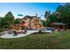 Resort-style backyard features a luxurious pool, spa, outdoor kitchen, fireplace, and a lush green lawn at 5330 Lake Redwine Nw Cv, Acworth, GA 30101