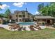 Expansive backyard with luxurious pool, slide, outdoor kitchen and lounge chairs at 5330 Lake Redwine Nw Cv, Acworth, GA 30101