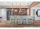 Finished basement bar featuring a brick backsplash, wood accents, seating, and modern lighting at 5330 Lake Redwine Nw Cv, Acworth, GA 30101