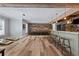 Basement with wet bar, wood floors, seating, and open recreational space at 5330 Lake Redwine Nw Cv, Acworth, GA 30101