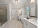 Luxurious bathroom with a glass-enclosed shower, freestanding tub, double vanity, and modern fixtures at 5330 Lake Redwine Nw Cv, Acworth, GA 30101
