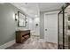 Stylish bathroom featuring a glass enclosed shower, modern vanity, and decorative storage at 5330 Lake Redwine Nw Cv, Acworth, GA 30101