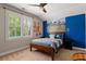 Bedroom featuring a baseball-themed wall mural, carpeted flooring, and a bright window at 5330 Lake Redwine Nw Cv, Acworth, GA 30101