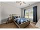 Cozy bedroom features a ceiling fan, carpet, and window with bright natural light at 5330 Lake Redwine Nw Cv, Acworth, GA 30101