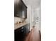 Butler's pantry features dark cabinets, light countertops, and hardwood floors at 5330 Lake Redwine Nw Cv, Acworth, GA 30101