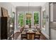 Dining room with wooden table, chandelier, and view to outdoors at 5330 Lake Redwine Nw Cv, Acworth, GA 30101