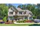 Charming two-story home boasts a manicured lawn, beautiful landscaping, and a welcoming front porch at 5330 Lake Redwine Nw Cv, Acworth, GA 30101