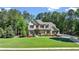 Beautifully landscaped home with a manicured lawn, colorful flowerbeds, and a long driveway at 5330 Lake Redwine Nw Cv, Acworth, GA 30101