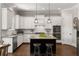 Modern kitchen features white cabinets, stainless steel appliances, granite countertops, and a center island with seating at 5330 Lake Redwine Nw Cv, Acworth, GA 30101