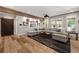 Open living room with wood floors, coffered ceiling, barn door, and comfortable seating at 5330 Lake Redwine Nw Cv, Acworth, GA 30101