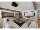 Open living room with home theater setup, wood beams, and comfortable seating at 5330 Lake Redwine Nw Cv, Acworth, GA 30101