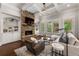 Inviting living room showcases a stone fireplace, built-in shelving, hardwood floors, and ample natural light at 5330 Lake Redwine Nw Cv, Acworth, GA 30101