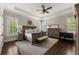 Spacious main bedroom features tray ceilings, hardwood floors, and large windows with plantation shutters at 5330 Lake Redwine Nw Cv, Acworth, GA 30101