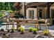 Elegant outdoor dining setup next to pool with stone pavers and landscaped surroundings at 5330 Lake Redwine Nw Cv, Acworth, GA 30101