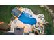 Aerial view of a custom pool with a slide, hot tub, swim-up bar, and outdoor kitchen, perfect for entertaining at 5330 Lake Redwine Nw Cv, Acworth, GA 30101