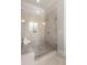 Modern shower with marble-look tile, a built-in bench, and sleek glass enclosure at 5330 Lake Redwine Nw Cv, Acworth, GA 30101