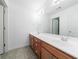 Bathroom boasts double vanity with wood cabinets and a tiled floor at 970 Samples Nw Ln, Atlanta, GA 30318
