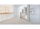 Upstairs hallway with carpeted floors and chandelier at 970 Samples Nw Ln, Atlanta, GA 30318