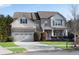 Two-story home with a three-car garage, brick and shingle exterior, and a manicured lawn at 2217 Spring Stone Ct, Buford, GA 30519