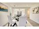 Bright dining area with a glass table and four chairs, hardwood floors, and large windows at 2633 Rainwater Ct, Decatur, GA 30034