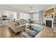 Open living room with kitchen view, featuring L-shaped sofa and hardwood floors at 2732 Piper Dr, Atlanta, GA 30331