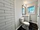 Modern bathroom with white subway tile and dark floor at 1394 Yates Ave, Austell, GA 30106