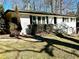 Updated white brick ranch house with landscaping and a walkway at 1394 Yates Ave, Austell, GA 30106