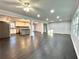 Open concept living space with dark hardwood floors and kitchen view at 1394 Yates Ave, Austell, GA 30106