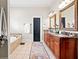 Elegant bathroom featuring double vanities, a soaking tub, and stylish accents, offering a luxurious experience at 4595 Carriage Walk Ln, Cumming, GA 30040