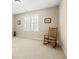 Spacious bedroom with neutral carpet, rocking chair, and natural light coming in through the window at 4595 Carriage Walk Ln, Cumming, GA 30040