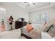 Relaxing bedroom with a dresser and plantation shutters, creating a peaceful and comfortable space at 4595 Carriage Walk Ln, Cumming, GA 30040