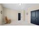 Large bedroom with neutral carpet and rocking chair, with black doors leading to other rooms in the home at 4595 Carriage Walk Ln, Cumming, GA 30040