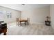 Spacious bonus room with neutral walls and carpet, window shutters, and table with chairs in the center at 4595 Carriage Walk Ln, Cumming, GA 30040