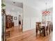 Open dining room with hardwood floors, chandelier, and decorative wall paneling at 4595 Carriage Walk Ln, Cumming, GA 30040